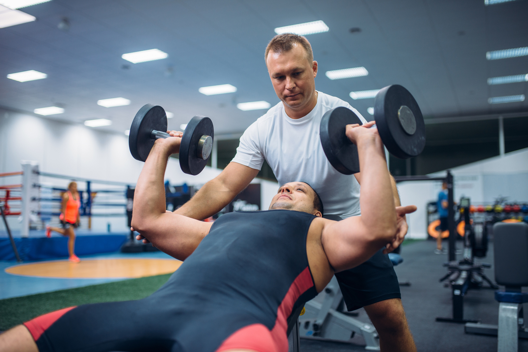 Athlete Doing Exercise under Instructor Control