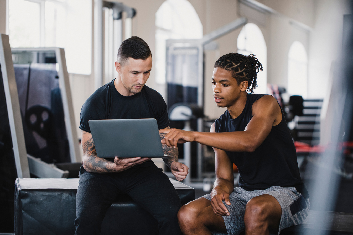 Personal Trainer Consulting with a Client