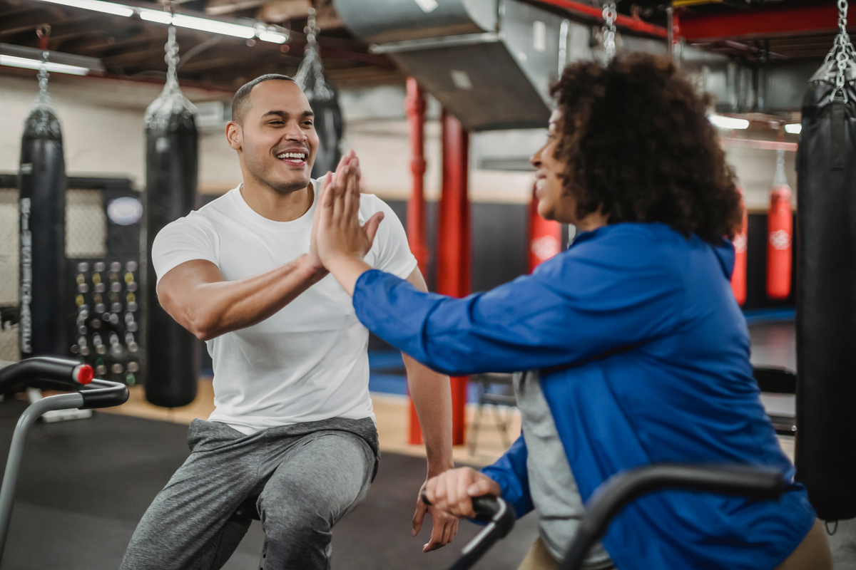 Happy multiethnic sportspeople clapping hands in gym